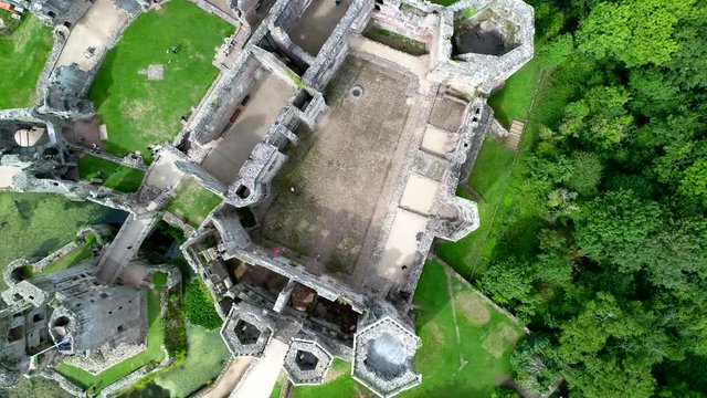 Aerial footage looking down at Raglan Castle while ascending