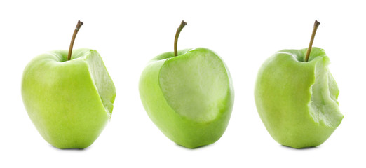 Set of delicious green apples with bite marks on white background
