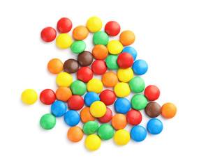 Tasty colorful candies on white background, top view