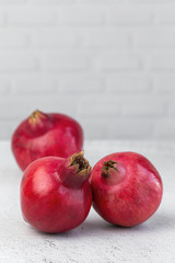 Fototapeta na wymiar Fresh and red pomegranate on light background