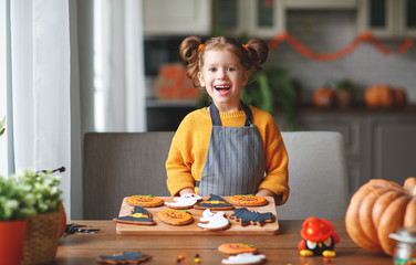 happy child girl in costumes of pumpkins are preparing for  holiday Halloween