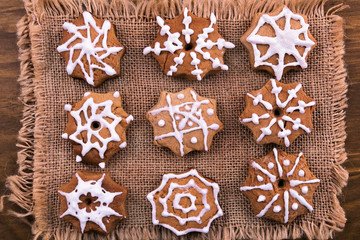 Star shaped cookies with icing sugar, laid on a linen napkin, wooden background.