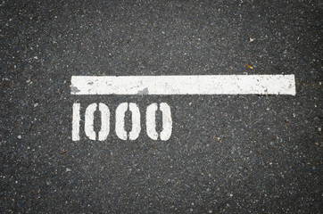 1000m marker of running track on asphalt