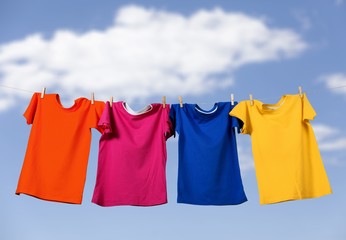 Colorful T-shirts hanging on a rope on