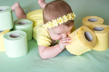 A Toddler ripping up toilet paper in bathroom studio