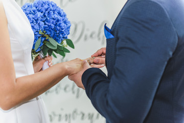 Bride and groom wearing wedding rings