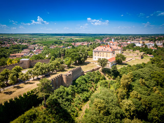 Fototapeta na wymiar Aerial summer panorama of ruined Ilok castle on the Croatian Serbian border above the Danube river in Croatia with blue sky