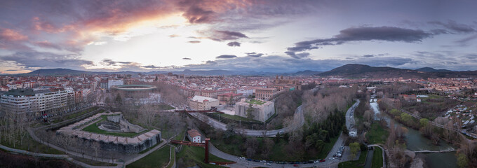 Aerial sunset panorama of medieval Pamplona, view of the cathedral, bastions, city walls with orange, yellow, blue sky in Navarra, Spain