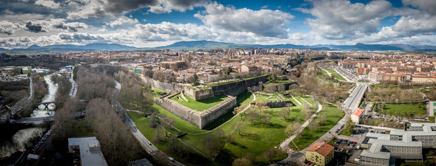 Aerial panorama view of fortified medieval Pamplona in Spain with dramatic cloudy blue sky