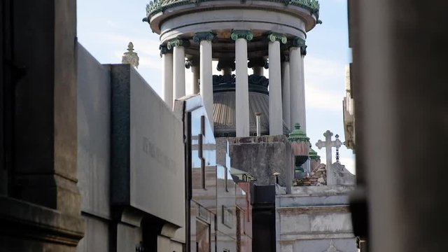 Old Mausoleum and street in La Recoleta Cementery at daytime tilt down to high