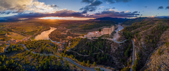 Aerial sunrise view of Miravet templar crusader castle and ebro river province of tarragona Spain...