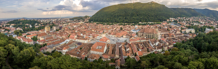 Fototapeta na wymiar Brasov cityscape aerial view with balck church, white tower, red roofs in Romania