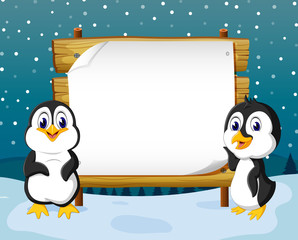 the winter view with the wooden board blank space and two penguins stand in front it 
