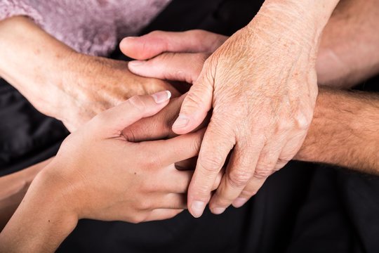 Man and Woman Hands Holding an Old Woman's Hands