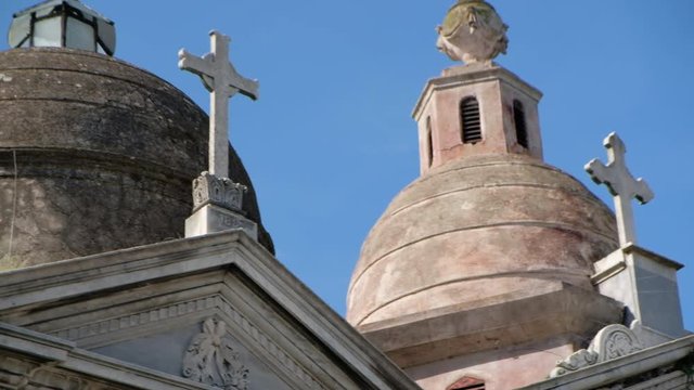 Mausoleum domes with crosses at daytime in La Recoleta Cementery tight shot panning right to left