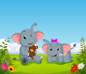 the natural view with the two elephant playing the doll in the yard 
