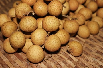 Longan fruits or Dimocarpus longan or Dragon eye fruit on the wooden wicker.