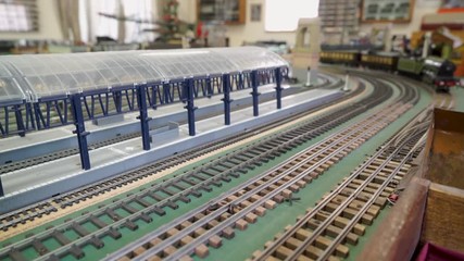 Hobby toy vintage trains on  train layout pass by camera.