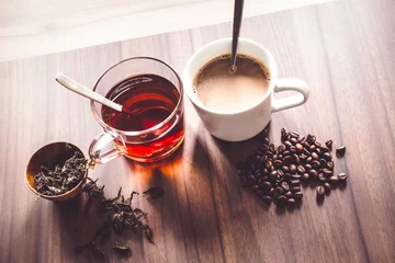 Foto op Plexiglas Coffee and tea with coffee bean and tea leaves on wooden floor. © yaisirichai