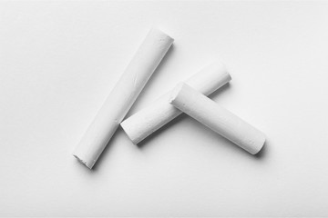 Three White chalks on white background