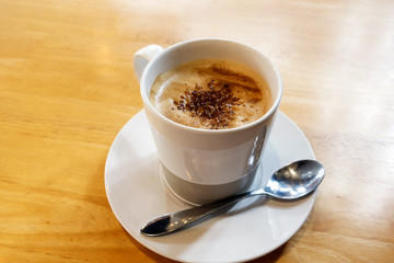 Hot coffee on wooden table