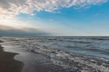 Coast, cloudy weather, waves on the sea