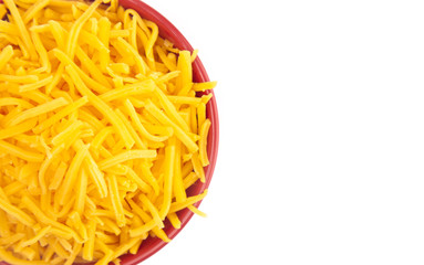 Bowl of Grated Cheddar Cheese on a White Background