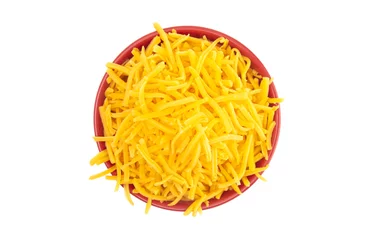Gardinen Bowl of Grated Cheddar Cheese on a White Background © pamela_d_mcadams