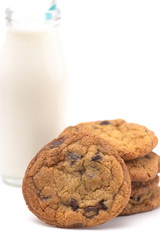 Stack of Chocolate Chip Cookies and a Glass Jar of Milk