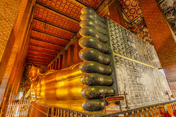 Reclining Buddha statue in Wat Pho Temple Bangkok, Thailand. an Asian style Buddha Art, open to worship. 