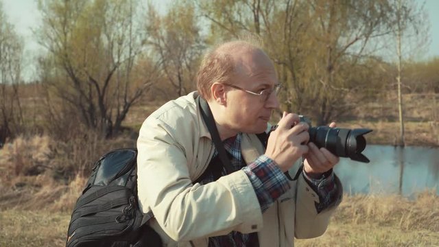 Photographer travel and takes pictures in nature.