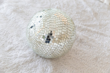close up of silver disco ball on messy wool.