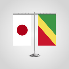 Table stand with flags of Japan and Republic of the Congo.Two flag. Flag pole. Symbolizing the cooperation between the two countries. Table flags