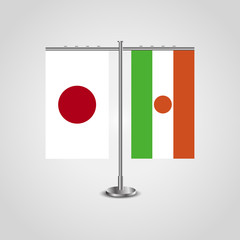Table stand with flags of Japan and Niger.Two flag. Flag pole. Symbolizing the cooperation between the two countries. Table flags