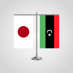 Table stand with flags of Japan and Libya.Two flag. Flag pole. Symbolizing the cooperation between the two countries. Table flags
