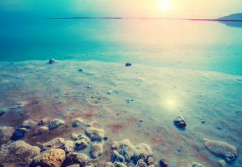 Early in the morning on the beach. The salty shore of the Dead Sea. Israel