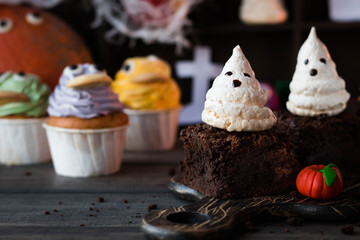 Brownie with ghosts of meringue as the idea of a dessert for Halloween