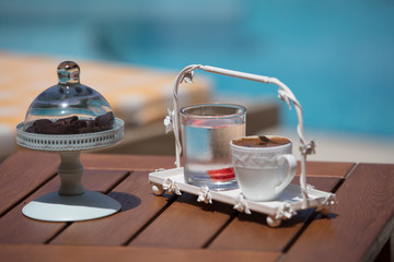 a cup of turkish coffee near the pool