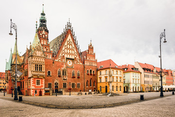 Fototapeta na wymiar Morning scene on Wroclaw Market Square with Town Hall. Cityscape in historical capital of Silesia, Poland, Europe