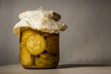small glass jar with homemade canned sliced zucchini
