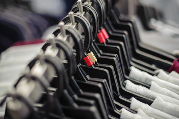 Fototapeta premium Clothes hang on shelf in a clothing store