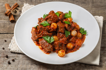 A traditional Greek dish of beef stifado in a sauce. The view from the top. Copy-space.