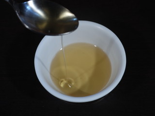 Sesame oil inn White Bowl on Wooden Background,Til ka Tel called in India, Tilli Ka Tel,Sesame oil,Bottle of sesame oil and sesame seeds isolated on white background