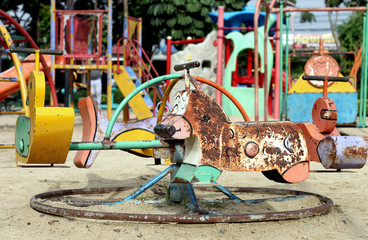 Fototapeta na wymiar old scary dirty abandon playground on sand