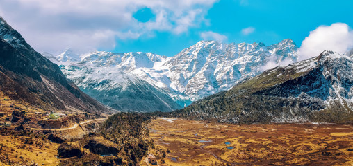 Aerial view of North Sikkim landscape with barren mountain terrain with Himalayan snow peaks.