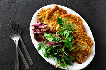 Comfort food Fried zucchini pancakes salad top view
