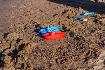 plastic baby boats on the sand.