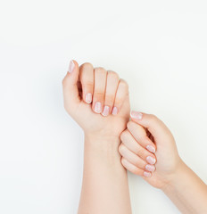 Manicure female hands with french nails on white background