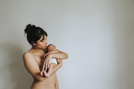 Naked Mother Holding Her Infant Baby