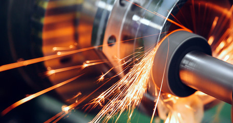 sparks flying while machine griding and finishing metal - obrazy, fototapety, plakaty